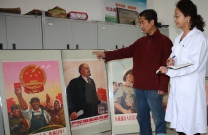 自治区档案馆收集整理部副主任甘峰岭（右）正在登记呼和浩特市民张权选送的红色展品